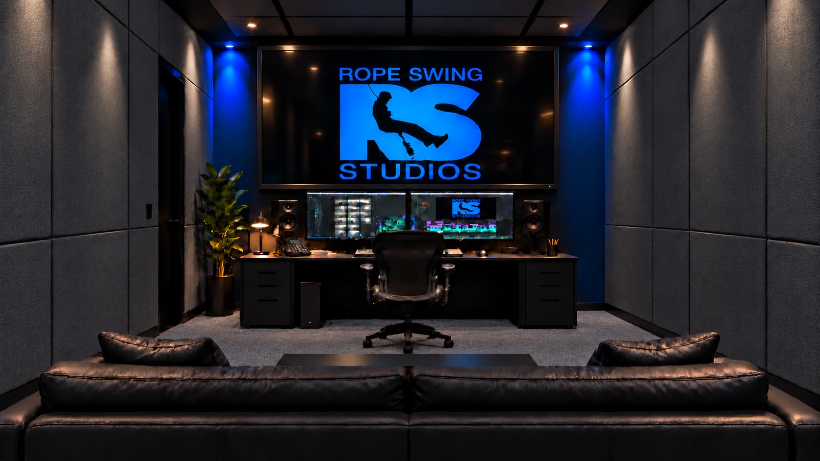 Compact picture editing bay with charcoal acoustic panels and cobalt accent lighting
